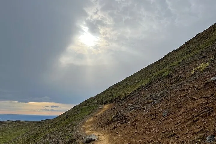 Hikers on the ridge of Mount Helgafell above Hafnarfjordur on an Iceland volcano hike