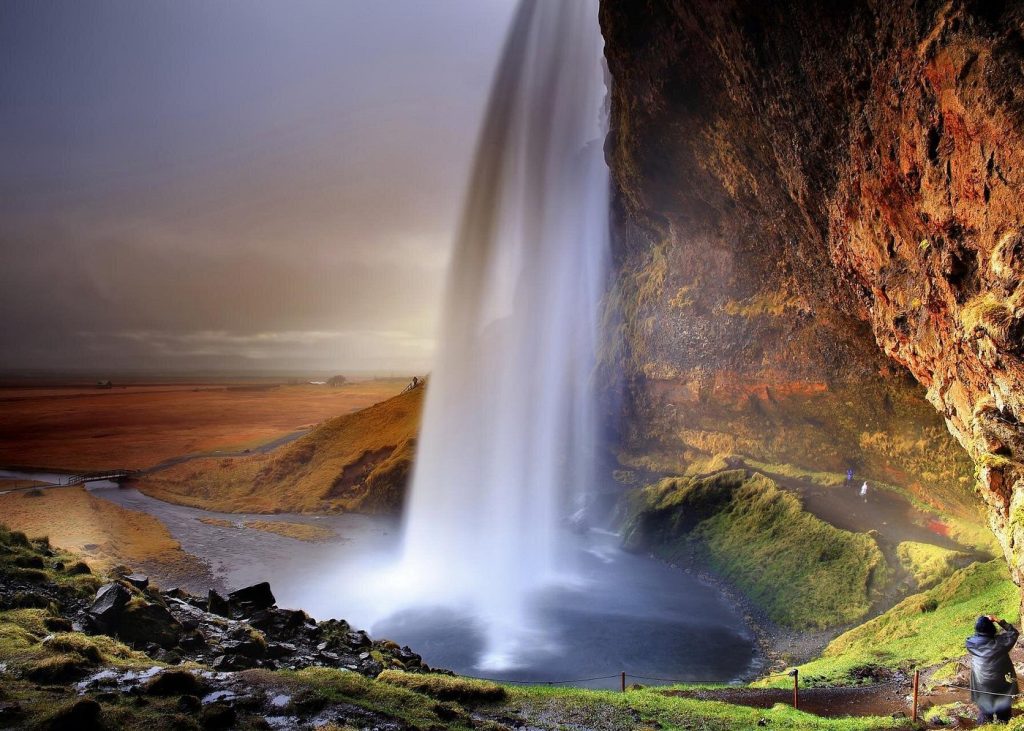 Seljalandsfoss waterfall cascading over a cliff into a pool at sunset — South Coast Tour from Reykjavik: Volcanoes, Glaciers & Waterfalls

